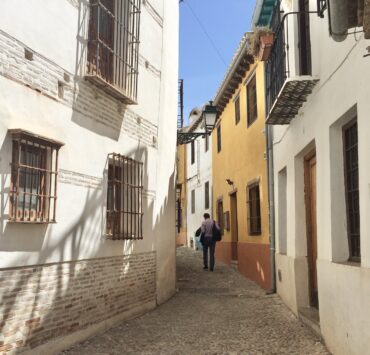 A man walks on an empty street.