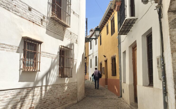 A man walks on an empty street.