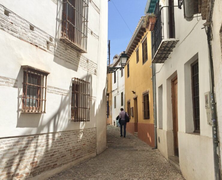A man walks on an empty street.