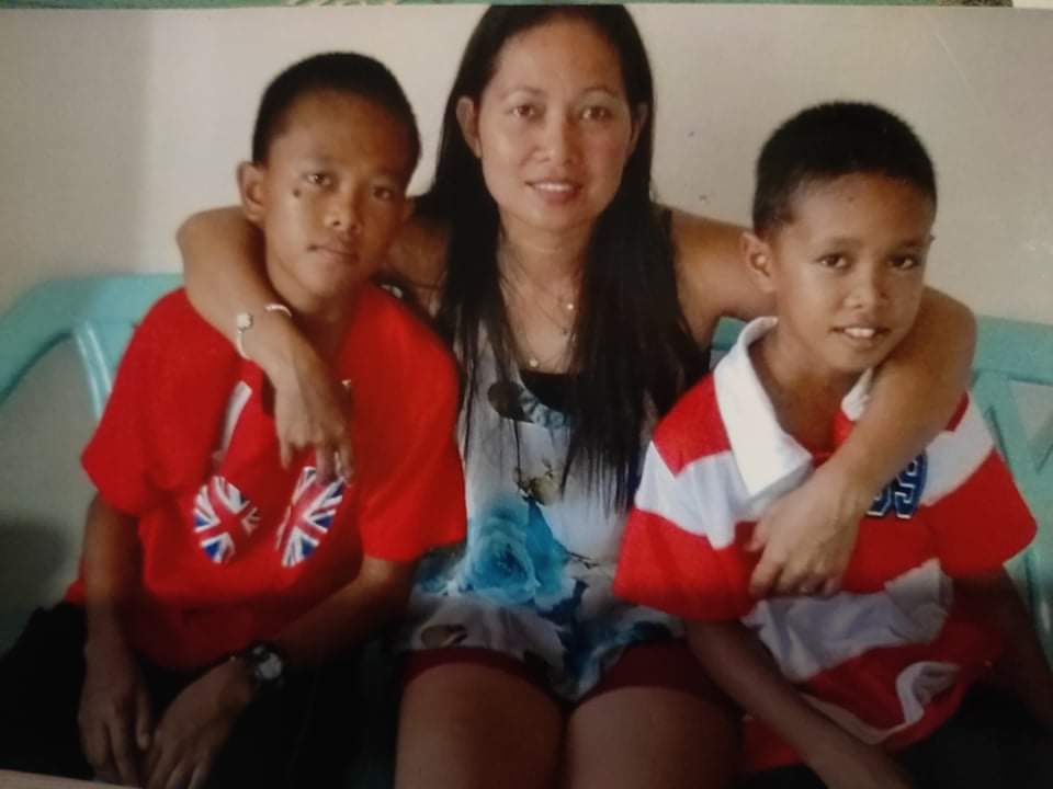 An OFW with her sons whom she almost lost during of the typhoons in the Philippines.