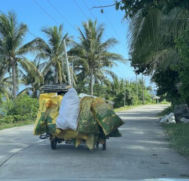 A tricycle drives into a provincial road in rural Philippines. Photo DM Aguilar